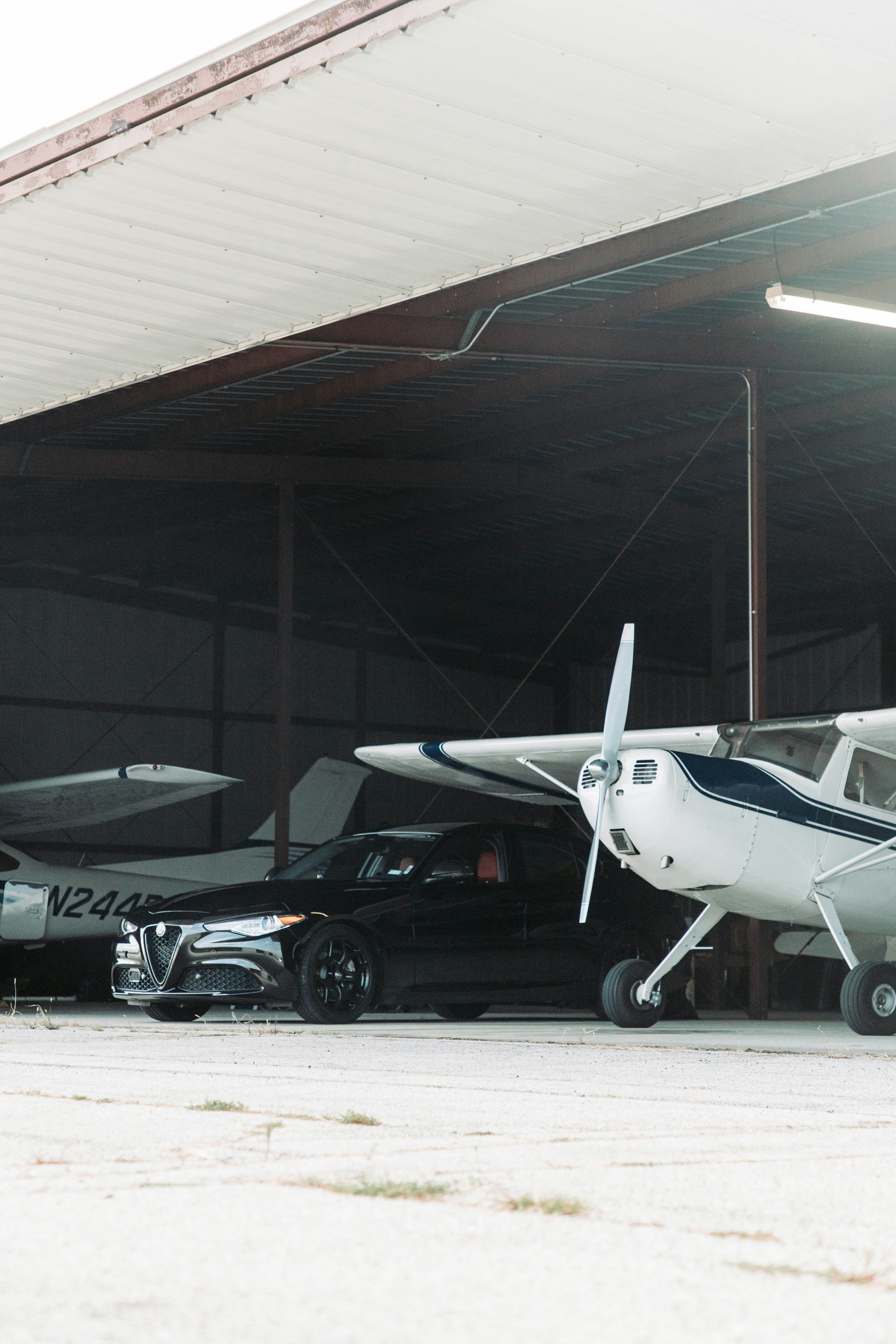 Aircraft and car in hangar